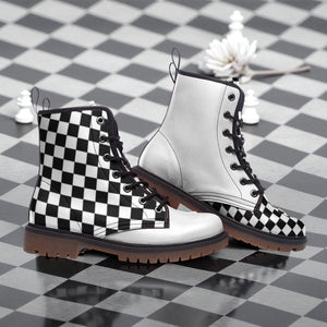 A pair of black and white checkered boots with a white sole, placed on a black and white checkered floor.