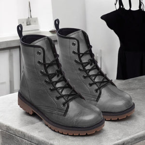 a pair of gray boots sitting on top of a counter