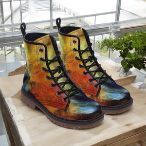 a pair of colorful boots sitting on top of a wooden table