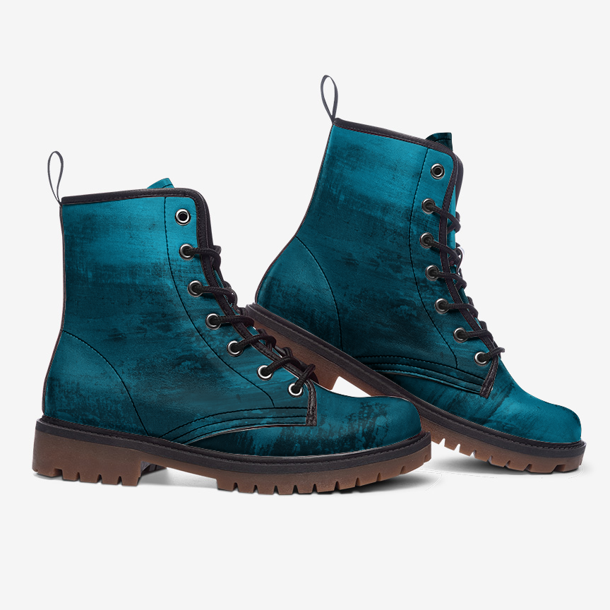 a pair of teal colored boots on a white background