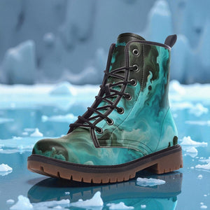 A pair of green and black patterned boots with a textured sole, placed on a surface with ice and snow.