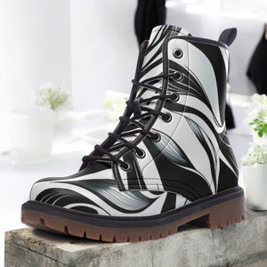 a pair of black and white boots sitting on top of a cement block