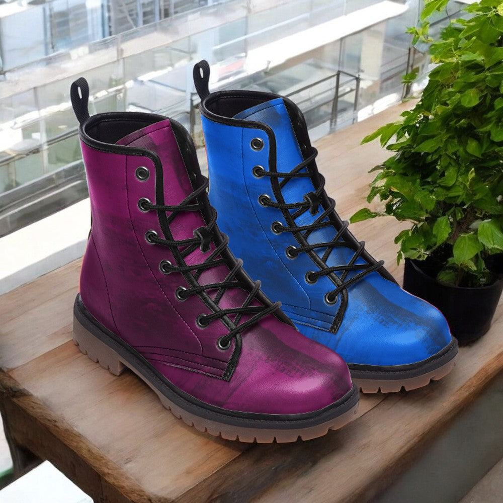 a pair of colorful boots sitting on top of a wooden table