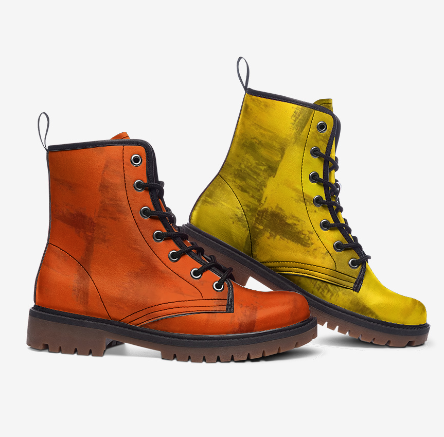 a pair of orange and yellow boots on a white background