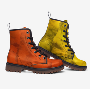 a pair of orange and yellow boots on a white background