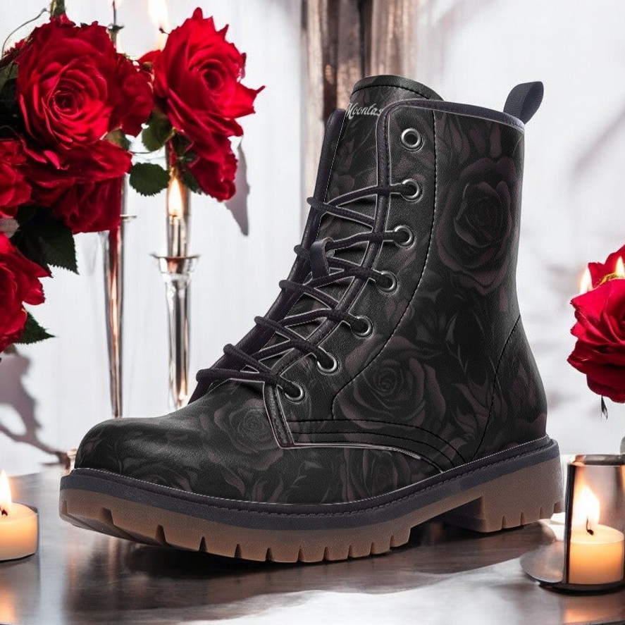 a pair of black boots sitting on top of a table