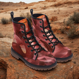 a pair of red boots sitting on top of a rock