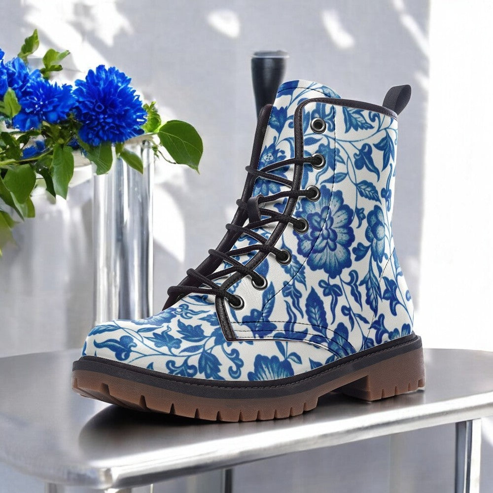 a pair of blue and white boots sitting on top of a table