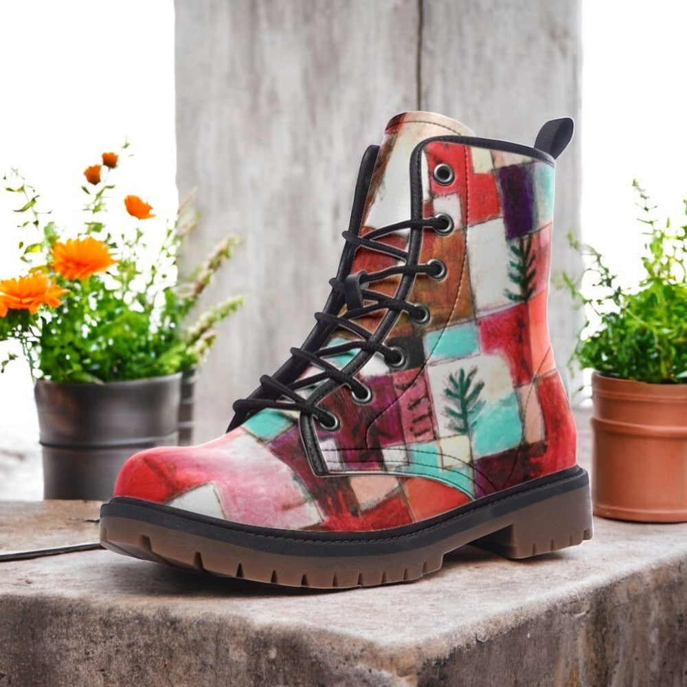 a pair of colorful boots sitting on top of a stone slab