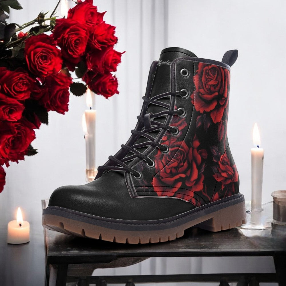 A black boot with red rose designs on the side, placed on a table with lit candles and red roses in the background.