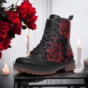 A black boot with red rose designs on the side, placed on a table with lit candles and red roses in the background.