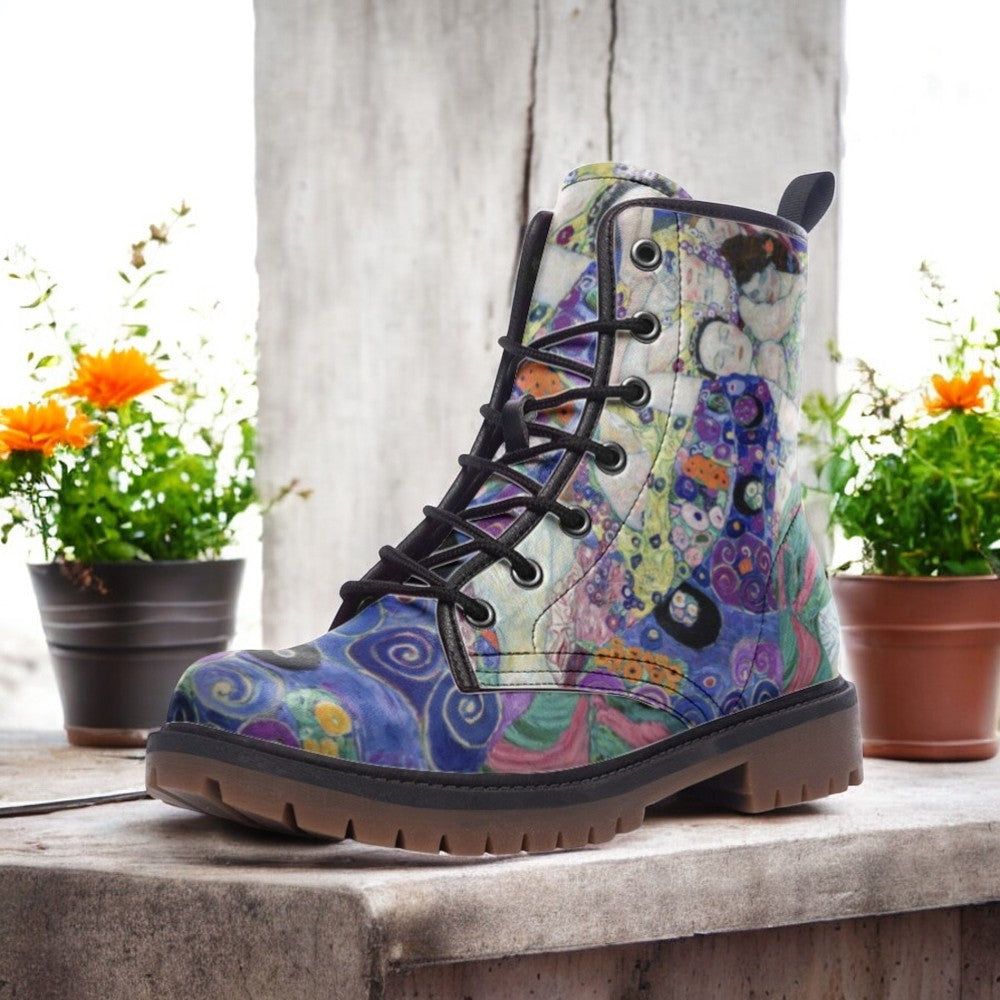 a pair of colorful boots sitting on top of a wooden table