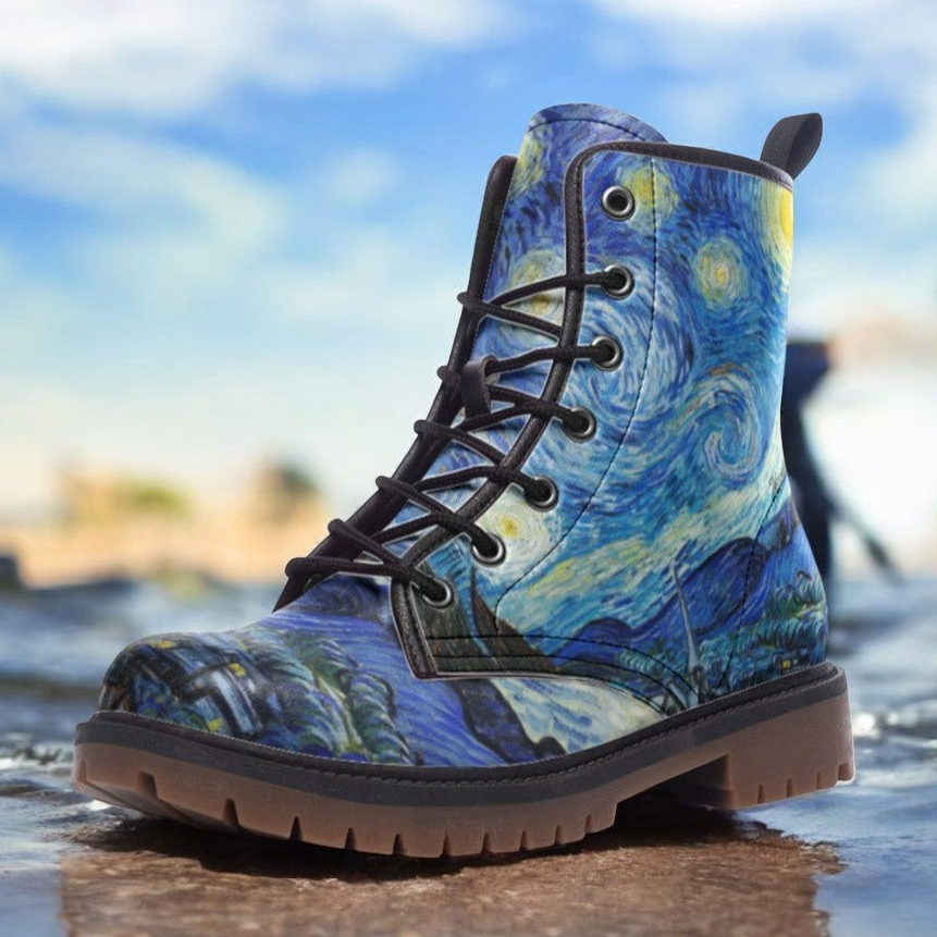 a close up of a pair of boots with a painting on them