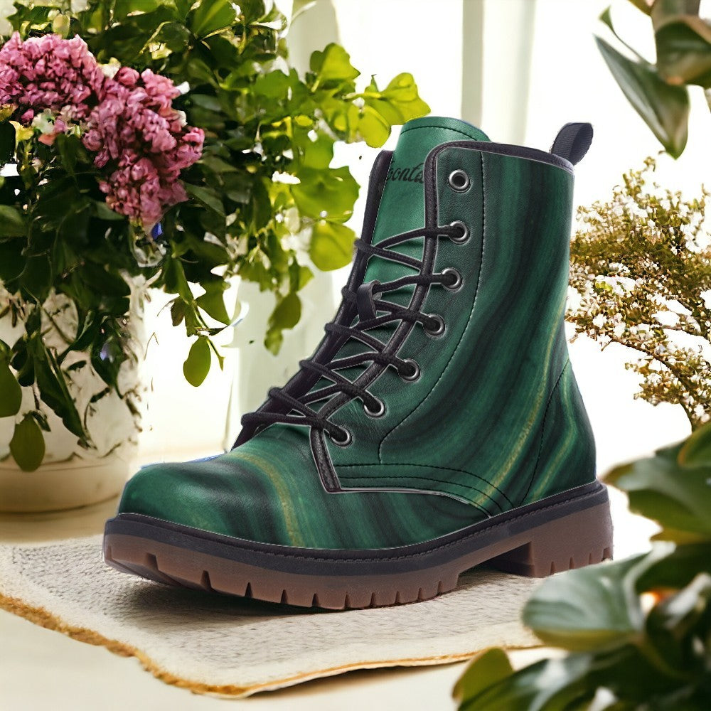 a pair of green boots sitting next to a potted plant