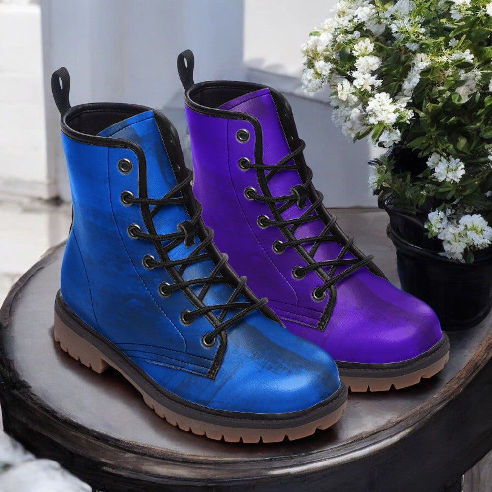 a pair of purple and blue boots sitting on top of a table