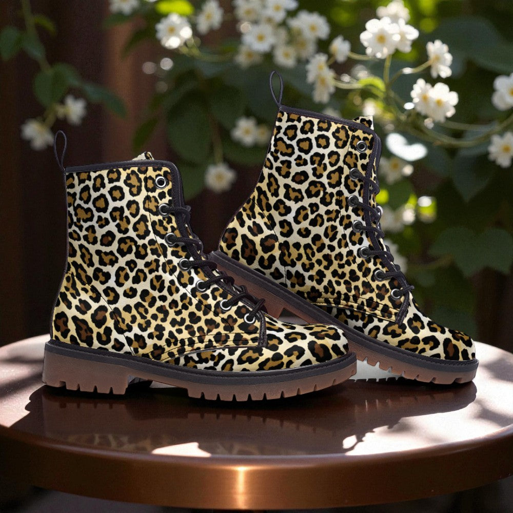 A pair of leopard print boots is displayed on a wooden surface, with white flowers visible in the background.