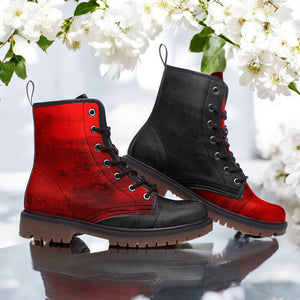 A pair of red and black combat boots with a floral pattern, displayed against a backdrop of white flowers.