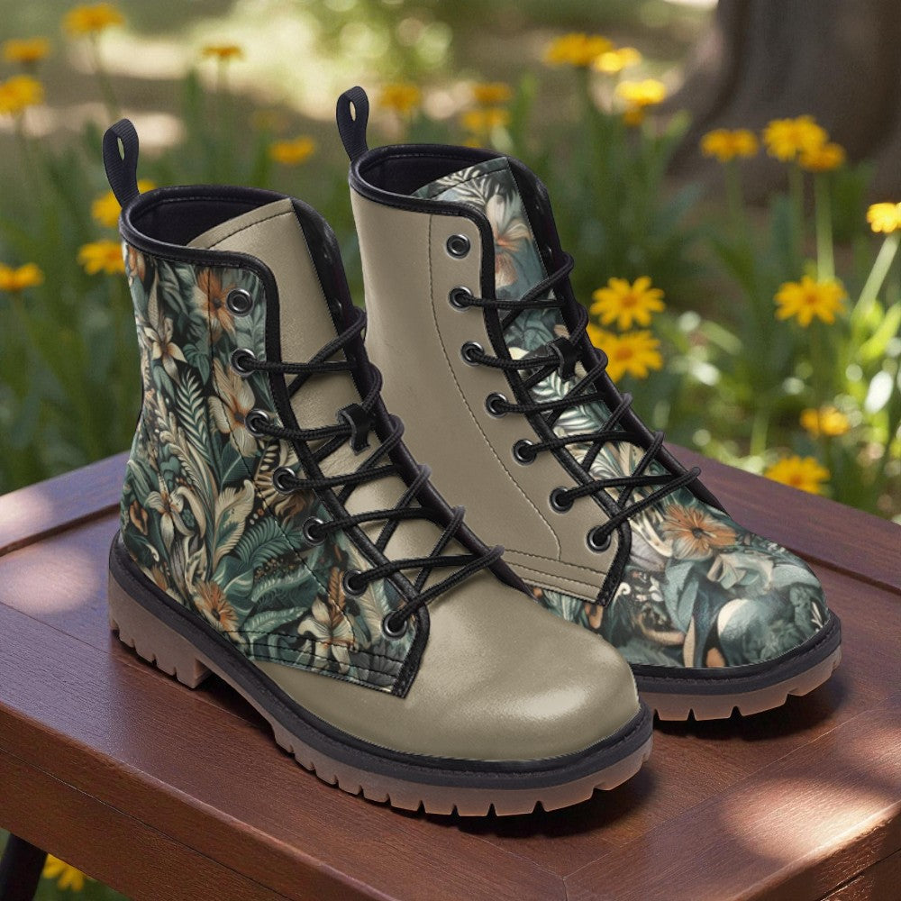 A pair of tan boots with a floral print pattern, placed on a wooden surface against a background of yellow flowers.