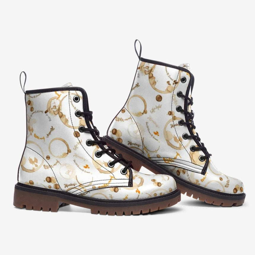 a pair of white boots with gold and black designs