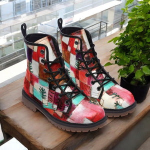 a pair of colorful boots sitting on top of a wooden table